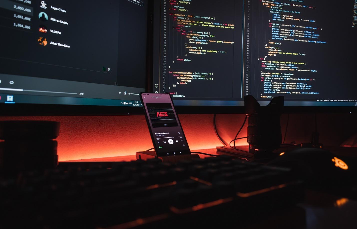 cell phone and computers on a desk