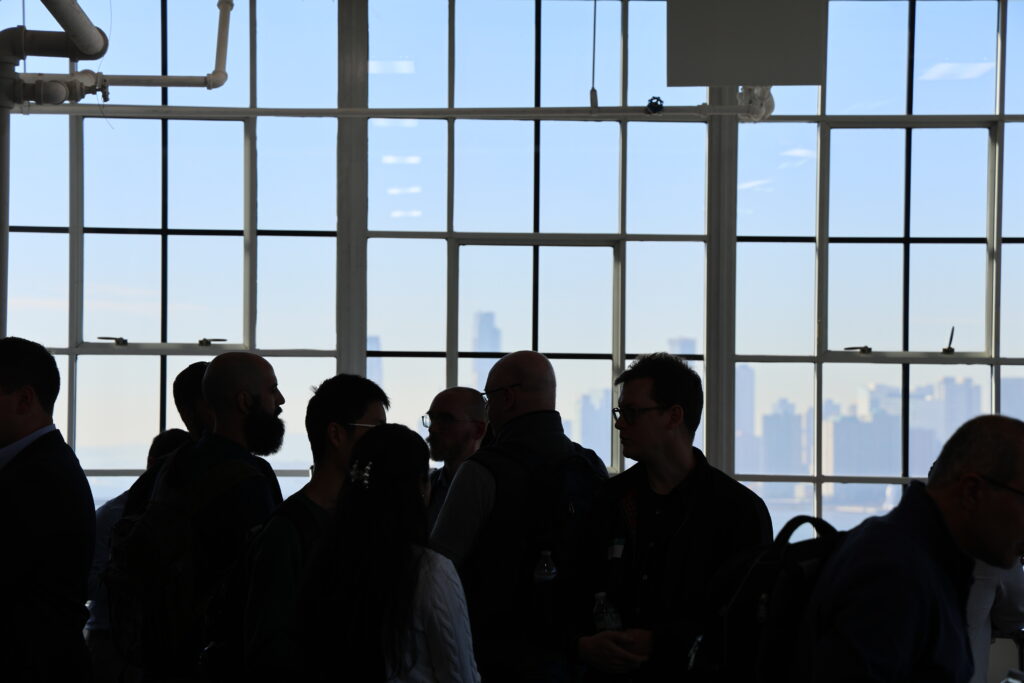 NetDevOps Day New York attendees mingle with a beautiful water view in the background